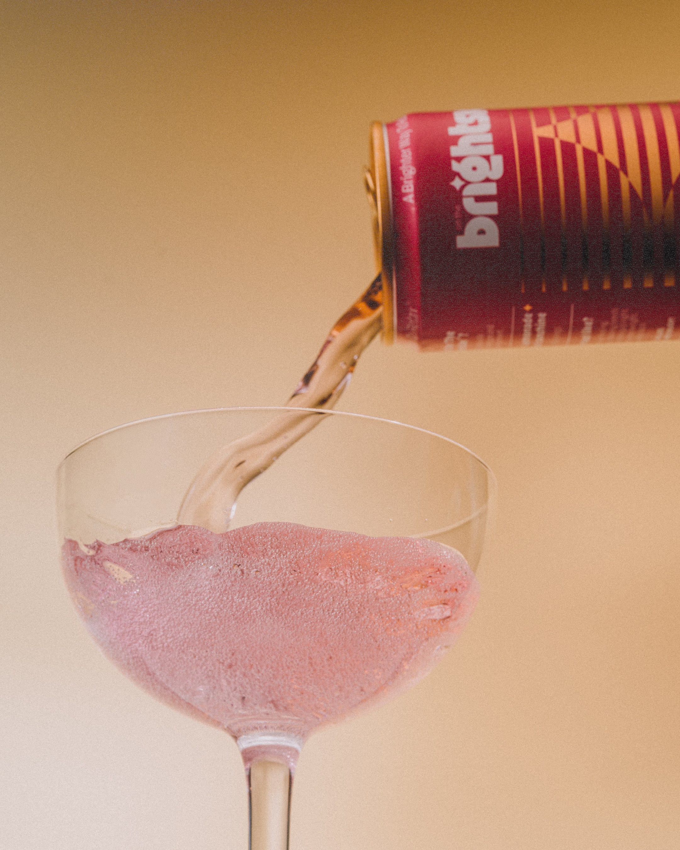 can of strawberry sunshine being poured into drinking glass