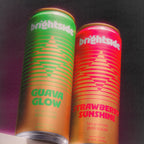 Two cans of Brightside drinks, one Guava Glow and one Strawberry Sunshine, on a dark background.