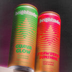 Two Brightside beverage cans standing upright against a dark background. The left can is Guava Glow, the right can is Strawberry Sunshine.